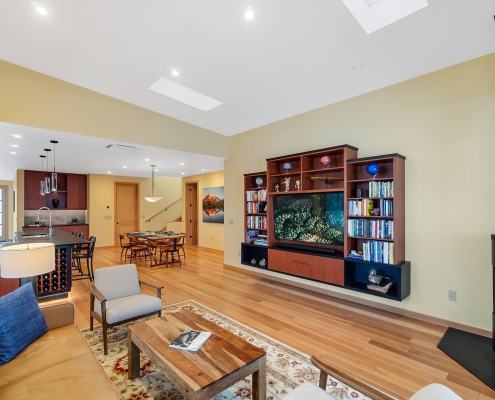 redesigned home interior with open floor plan, floating cabinets, and firieplace