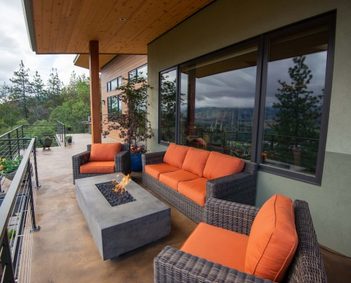 functional modern outdoor living spaces on wraparound deck at modern design home with view in Ashland, Oregon