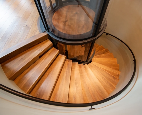 modern spiral staircase design with wood flooring and stairs in Ashland, Oregon home